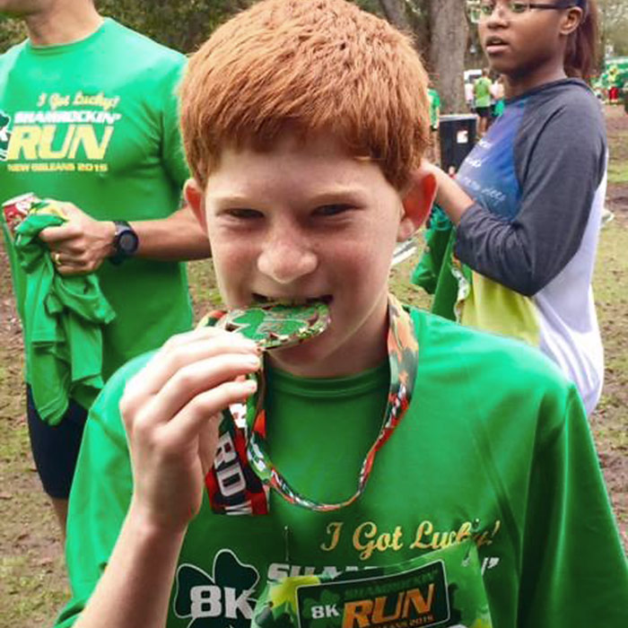 Runner biting his Shamrockin' Run award